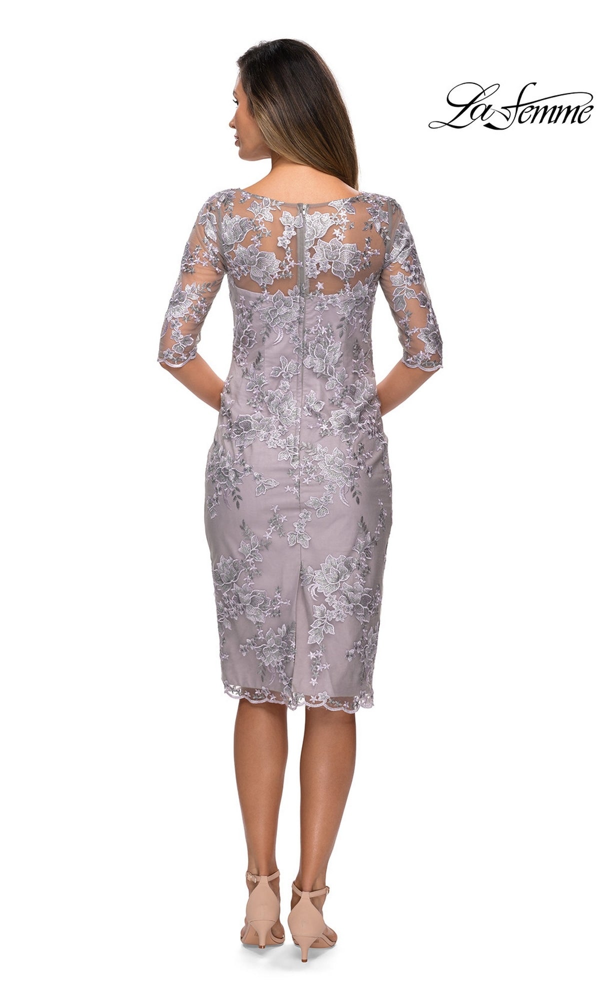 Woman facing away in Knee Length Wedding Guest Dress: La Femme 27895, a floral lace sheath with sheer sleeves and nude heels—perfect for a wedding guest look.